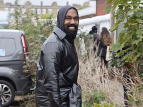 Kanye West smiling during London Fashion Week.