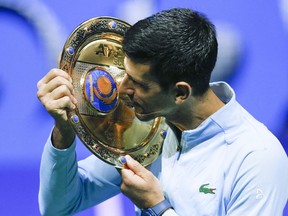 Serbia's Novak Djokovic poses with the trophy after winning the final tennis match of the ATP 500 Astana Open tennis tournament against Stefanos Tsitsipas of Greece in Astana, Kazakhstan, Sunday, Oct. 9, 2022.