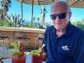 Ken Slack, former 'sixtysomething' SUNshine Boy now 90 years old, sitting at table with two Caesars.