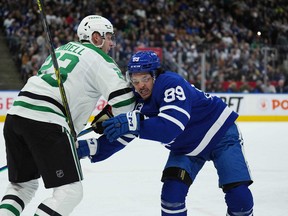 Maple Leafs' Nick Robertson (right) battles with Dallas Stars' Esa Lindell during the first period at Scotiabank Arena on Thursday, Oct. 20, 2022.