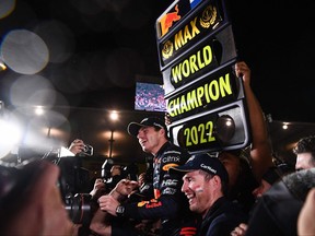 Red Bull Racing's Dutch driver Max Verstappen, centre, celebrates winning the season's world championship after his victory at the Formula One Japanese Grand Prix at Suzuka, Mie prefecture on Oct. 9, 2022.