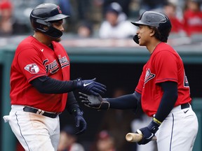 Josh Naylor (left) of the Cleveland Guardians celebrates with his brother Bo after hitting a home run at Progressive Field on October 2, 2022 in Cleveland, Ohio.