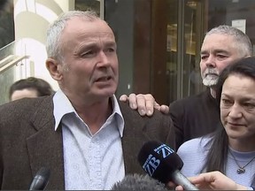 In this image made from a video, Mark Ellis, left, brother of Peter Ellis, speaks to the media outside a court in Wellington Friday, Oct. 7, 2022.