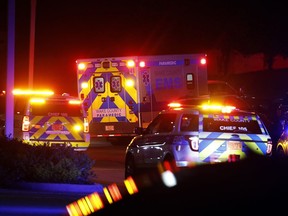 An ambulance believed to be carrying a shooting suspect arrives at Wake Medical Center Emergency Room in Raleigh, N.C., Thursday, Oct. 13, 2022, surrounded by police.