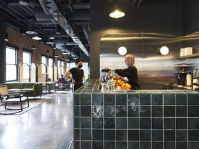 Workers are seen around a cafe-style bar in Lightspeed's Montreal office in an undated handout photo. When Lightspeed Commerce Inc. staff headed back to the office this year after a pandemic hiatus, they found a space double the size of their last with a restaurant serving free meals, a smoothie bar and a barista to craft custom drinks.