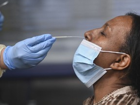 A health-care worker tests a woman at a pop-up COVID-19 assessment centre in Toronto on May 19, 2021. The burden of COVID-19 going forward will sit on the shoulders of primary care doctors and nurses if no new variant emerges, but the way that medical care is delivered must be reconsidered, Ontario's now-defunct science table said Monday in its final bit of advice to the province.
