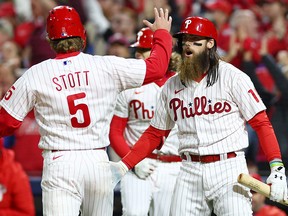 Bryson Stott of the Philadelphia Phillies celebrates with Brandon Marsh after scoring against the San Diego Padres in Game 3 of the NLCS at Citizens Bank Park on October 21, 2022 in Philadelphia.
