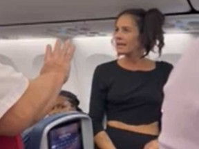 A passenger who was kicked off a flight for having her dog on her lap is pictured in a screegrab taken from a video posted on Reddit.