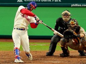Bryce Harper of the Philadelphia Phillies hits a two-run home run against the San Diego Padres in Game 5 of the National League Championship Series at Citizens Bank Park on October 23, 2022.