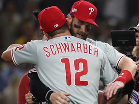 Philadelphia Phillies left fielder Kyle Schwarber celebrates with designated hitter Bryce Harper (3) after Game 1 of the NLCS.