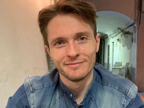 Man wearing denim shirt.
