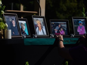 People set up a memorial table with images of the victims of a shooting in the Hedignham neighbourhood on Oct. 15, 2022 in Raleigh, North Carolina. Susan Karnatz is pictured in the photo on the far right.
