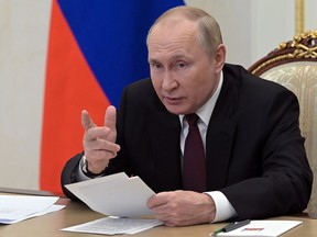 WAIT A SECOND! Russian President Vladimir Putin chairs a meeting with the heads of delegations of the Conference of Heads of Security and Intelligence Agencies of the Commonwealth of Independent States countries via a videoconference at the Kremlin in Moscow, Russia, Wednesday, Oct. 26, 2022.
