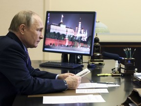 Russian President Vladimir Putin attends a meeting on economic issues via videoconference at the Novo-Ogaryovo residence outside Moscow, Russia, Thursday, Oct. 6, 2022.