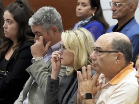 From left, Abby Hoyer, Tom and Gena Hoyer, and Michael Schulman react during the reading of jury instructions in the penalty phase of the trial of Marjory Stoneman Douglas High School shooter Nikolas Cruz at the Broward County Courthouse in Fort Lauderdale, Fla. on Wednesday, Oct. 12, 2022.