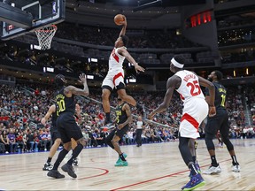 Raptors’ Scottie Barnes throws down a dunk over top of Jazz guard Jordan Clarkson in Edmonton last night.