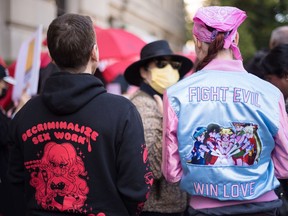 Sex workers and their supporters gather outside the Ontario Superior Court in Toronto during the launch of their constitutional challenge to Canada's sex work laws, on Monday, Oct. 3, 2022. THE CANADIAN PRESS/ Tijana Martin