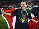 Christine Sinclair of Portland Thorns FC drapes the Canadian National flag around herself after winning the 2022 National Womens Soccer League Championship Match against  Kansas City Current on the weekend.  