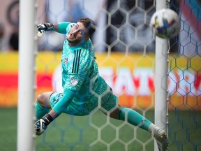 Toronto FC goalkeeper Alex Bono allows a goal to Vancouver Whitecaps' Brian White during the first half of the Canadian Championship soccer final, in Vancouver, on Tuesday, July 26, 2022.