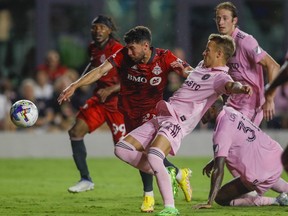 Aug 20, 2022; Fort Lauderdale, Florida, USA; Toronto FC midfielder Jonathan Osorio (21) keeps Inter Miami CF midfielder Bryce Duke (22) from reaching the ball during the second half at DRV PNK Stadium.