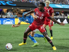 Aug 27, 2022; Charlotte, North Carolina, USA; Toronto FC defender Richie Laryea (19) steals the ball from Charlotte FC midfielder Benjamin Bender (15) during the first half at Bank of America Stadium.
