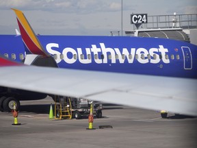 A Southwest Airlines jetliner sits at a gate