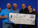 The family of Anne Zacerkowny of Sudbury picks up a cheque for $300,000 at the OLG Prize Centre in Toronto. 