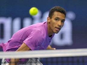 Canada's Felix Auger-Aliassime returns a ball to Kazakhstan's Alexander Bublik during their quarterfinal match at the Swiss Indoors tennis tournament at the St. Jakobshalle in Basel, Switzerland, Friday, Oct. 28, 2022.