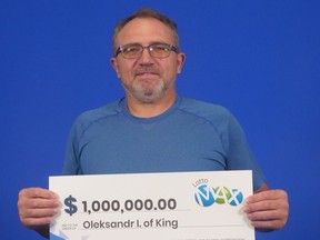 Oleksandr Ivanchenko of King with his $1 million from the Sept. 23, 2022 Lotto Max draw.