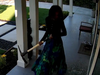 Still image of pickaxe-wielding woman smashing windows of home in Pasadena, Calif.