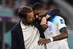 England coach Gareth Southgate congratulates forward Marcus Rashford as he is substituted after scoring two goals.