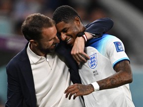 England coach Gareth Southgate congratulates  forward Marcus Rashford as he is substituted after scoring two goals.