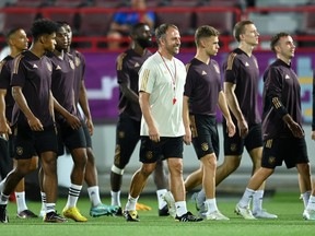 Germany coach Hansi Flick walks with the team during training.
