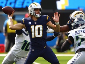 Justin Herbert of the Los Angeles Chargers throws the ball during the first half of the game against the Seattle Seahawks.