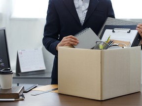 Businesswoman packing personal company belongings when she deciding resignation change of job or fired from the company.