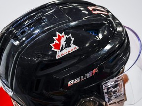 A Hockey Canada logo is visible on the helmet of a national junior team player during a training camp practice in Calgary, Tuesday, Aug. 2, 2022.