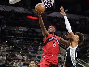 Toronto Raptors forward Precious Achiuwa (5) drives to the basket against San Antonio Spurs forward Dominick Barlow.