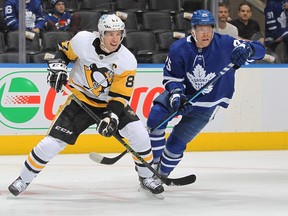 Sidney Crosby of the Pittsburgh Penguins skates against Ondrej Kase of the Toronto Maple Leafs during an NHL game at Scotiabank Arena on February 17, 2022 in Toronto, Ontario, Canada.