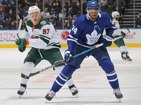Kirill Kaprizov of the Minnesota Wild skates against Wayne Simmonds of the Toronto Maple Leafs during an NHL game at Scotiabank Arena on February 24, 2022 in Toronto, Ontario, Canada.