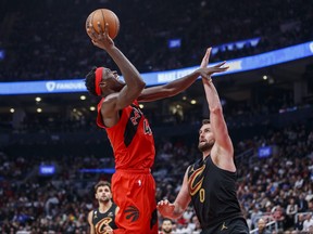 Pascal Siakam of the Toronto Raptors puts up a shot over Kevin Love of the Cleveland Cavaliers during the second half at Scotiabank Arena on October 19, 2022 in Toronto, Canada.
