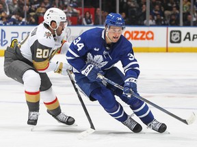 Auston Matthews of the Toronto Maple Leafs looks for a puck against Chandler Stephenson of the Vegas Golden Knights during an NHL game at Scotiabank Arena on November 8, 2022 in Toronto, Ontario, Canada.
