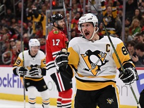 Sidney Crosby of the Pittsburgh Penguins celebrates after scoring a goal in the third period against the Chicago Blackhawks on November 20, 2022 at United Center in Chicago, Illinois. Pittsburgh defeated Chicago 5-3.