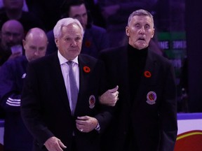 Darryl SIttler (left) and Borje Salming walk out for ceremonies prior to the Toronto Maple Leafs against the Pittsburgh Penguins at the Scotiabank Arena.