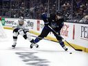 Mark Giordano of the Toronto Maple Leafs skates the puck against Trevor Moore of the Los Angeles Kings in the second period at Crypto.com Arena on October 29, 2022 in Los Angeles, California.