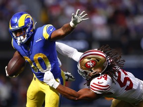 Ronnie Rivers of the Los Angeles Rams is tackled by Fred Warner of the San Francisco 49ers during the second quarter at SoFi Stadium on October 30, 2022 in Inglewood, California.