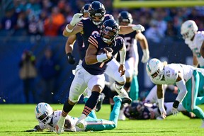 QB Justin Fields of the Chicago Bears runs the ball during the second half in the game against the Miami Dolphins at Soldier Field on November 06, 2022 in Chicago, Illinois.