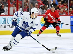 Morgan Rielly of the Toronto Maple Leafs moves the puck against the Carolina Hurricanes during the second period of their game at PNC Arena on November 06, 2022 in Raleigh, North Carolina.