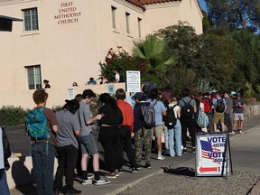 Voters wait to cast their ballots on Nov. 08, 2022 in Tucson, Ariz.