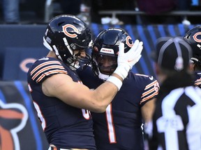 Chicago Bears quarterback Justin Fields (1) celebrates with Chicago Bears tight end Cole Kmet after he runs for a touchdown against the Detroit Lions.