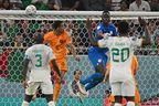 Netherlands' Cody Gakpo (second from left) scores in a 2022 World Cup Group A football match past Senegalese goalkeeper Edouard Mendy.